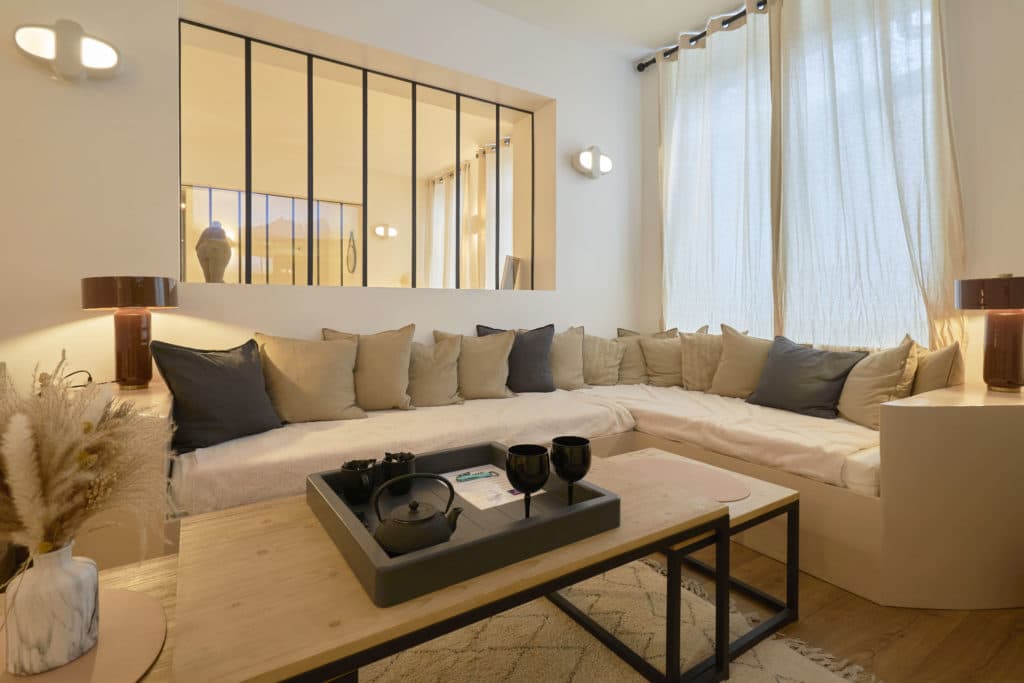 Salon cosy du cottage scandinave avec canapé beige et table basse moderne