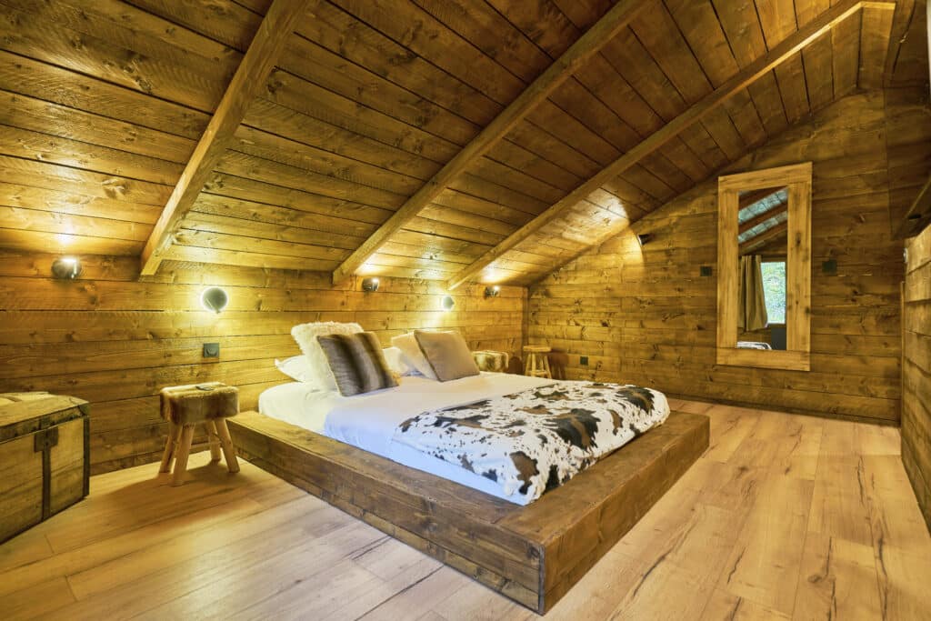 Chambre spacieuse du cottage Courchevel avec lit double et miroir mural